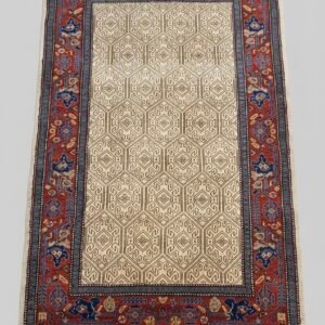 Hand-knotted Persian Malayer rug featuring a rich navy and terra cotta field with repeating geometric floral motifs and a sophisticated ivory border.