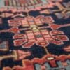 Detailed close-up of the central diamond medallion on a Hamedan Persian rug, showcasing the dense wool texture and floral-geometric symbols.