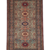 Full view of a 4' 7" x 7' 2" hand-knotted Persian Ardabil rug featuring a repeating geometric diamond medallion design on an ivory and terracotta field.