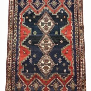 Full view of a 5' 3" x 6' 7" hand-knotted Persian Sirjan rug featuring a central diamond medallion on a deep navy and madder red field.
