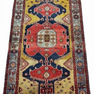 Full view of a 6' 8" x 4' 5" Hand-Knotted Persian Tarom Wool Rug featuring a central geometric medallion and a rich madder red and indigo blue field.