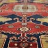 Close-up of the central medallion on a hand-knotted Tarom Persian rug showing detailed wool texture and traditional tribal motifs.