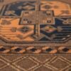 Detailed close-up of the geometric Gul motifs on a Turkmen rug, highlighting the fine knotting and velvety wool texture.