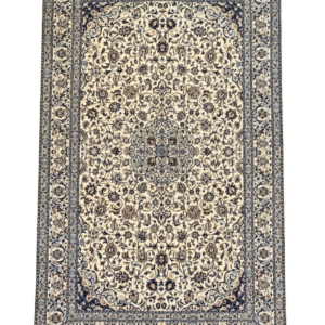 Full view of a 4' 12" x 7' 9" hand-knotted Persian Nain wool and silk rug featuring a central star medallion on an ivory field with navy blue borders.