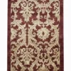 Full overhead view of a rectangular hand-knotted Afghan Chobi wool rug featuring a deep burgundy field with a large-scale cream acanthus leaf pattern.