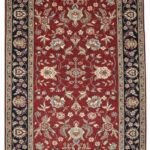 Full overhead view of a rectangular hand-knotted India Mashad wool rug with a deep red field and intricate floral vine patterns and a navy border.