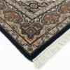 Detailed corner view of a navy Indian Bijar rug showing the multi-layered floral border and clean white hand-bound fringe.