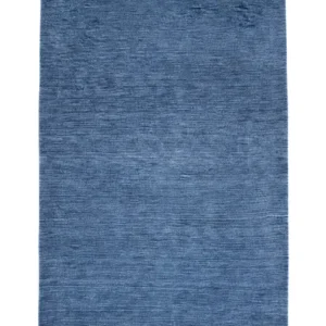 Full overhead view of a rectangular hand-knotted Indian Gabbeh wool rug in a solid denim blue with subtle abrash color variations.