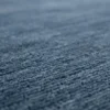 Macro shot showing the thick, plush hand-knotted wool pile and rich blue texture of an Indian Gabbeh area rug.