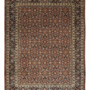Full overhead view of a rectangular hand-knotted Indian wool rug with a rich red field and a dense all-over floral pattern.
