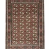 Full overhead view of a rectangular hand-knotted Indian wool rug with a rich burgundy field and an all-over repeating geometric medallion pattern.