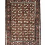 Full overhead view of a rectangular hand-knotted Indian wool rug with a rich burgundy field and an all-over repeating geometric medallion pattern.