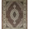 Full overhead view of a rectangular hand-knotted Indian wool rug featuring a burgundy-red field and a large, intricate cream and navy central medallion.
