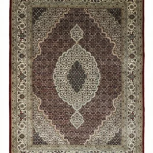 Full overhead view of a rectangular hand-knotted Indian wool rug featuring a burgundy-red field and a large, intricate cream and navy central medallion.