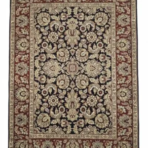 Full overhead view of a rectangular hand-knotted Indian wool rug with a rich red field and dense all-over ivory and blue floral patterns.