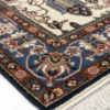 Detailed corner view of a Persian Bakhtiar rug showing the ornate blue floral border and clean white hand-bound fringe.