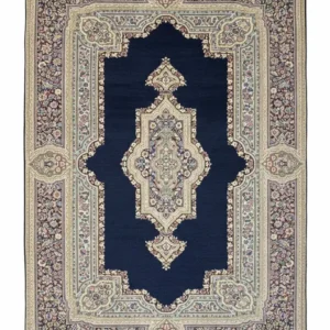 Full overhead view of a rectangular hand-knotted Persian Kerman wool rug with a deep navy blue field and a large ornate ivory and pink central medallion.