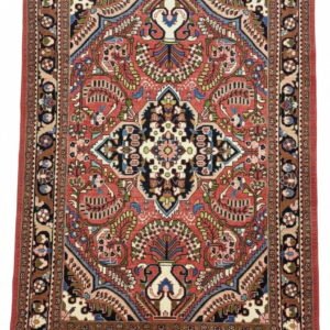 Full overhead view of a rectangular hand-knotted Persian Lilian wool rug with a vibrant rose-pink field and a central navy and cream floral medallion.