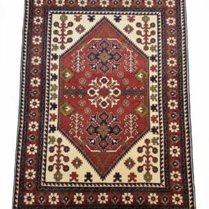 Full overhead view of a rectangular hand-knotted Afghan wool rug featuring a central red diamond medallion on a cream field with tribal floral motifs.