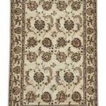 Full overhead view of a rectangular hand-tufted Indian wool rug with a cream field and symmetrical earth-toned botanical medallions.