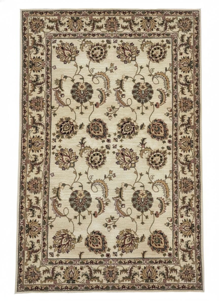 Full overhead view of a rectangular hand-tufted Indian wool rug with a cream field and symmetrical earth-toned botanical medallions.