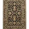 Full overhead view of a rectangular 5' 1" x 8' 3" hand-knotted Indian wool rug with a deep black field and intricate cream and ivory floral motifs.
