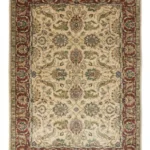 Full overhead view of a rectangular 5' 2" x 8' hand-knotted Indian wool rug with a rich burgundy field and dense all-over ivory and blue floral patterns.