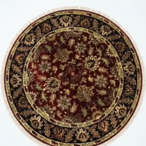 Full top-down view of a 6' x 6' circular hand-knotted Indian wool rug with a deep red field and an ornate navy and gold floral border.