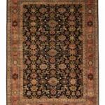 Full overhead view of a rectangular 5' 11" x 8' 9" hand-knotted Indo wool rug with a deep black field and an ornate terracotta-orange floral border.