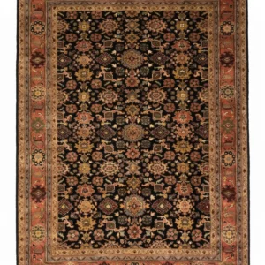 Full overhead view of a rectangular 5' 11" x 8' 9" hand-knotted Indo wool rug with a deep black field and an ornate terracotta-orange floral border.