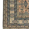 Detailed corner view of a Persian Ardabil rug showing the thin, elegant floral border and hand-bound fringe.