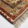 Detailed corner view of a Persian Qashqai rug showing the multi-layered geometric border and authentic hand-bound wool fringe.