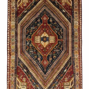 Full overhead view of a rectangular 5' 3" x 9' hand-knotted Persian Qashqai wool rug with a complex triple-diamond medallion on a deep navy and red field.