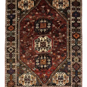 Full overhead view of a rectangular 5' 5" x 7' 8" hand-knotted Persian Qashqai wool rug with three large central medallions on a deep red and navy field.