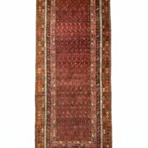 Full overhead view of a 3' 9" x 9' hand-knotted Turkish wool runner rug featuring repeating geometric medallions and a vibrant traditional palette.