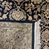 Close-up view of the underside of an Indian wool rug, showing the visible individual knots and authentic hand-bound textile construction.
