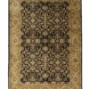 Full overhead view of a 5' 8" x 8' 5" hand-knotted Indian wool rug featuring a black field with dense gold and sage floral patterns and an ornate tan border.