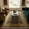 Elegant living room with a green velvet sofa and light wood floors, featuring a 5' 8" x 8' 5" black and gold Indian wool rug.