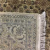 Close-up view of the underside of an Indian wool rug, showing the visible individual hand-tied knots and authentic textile construction.