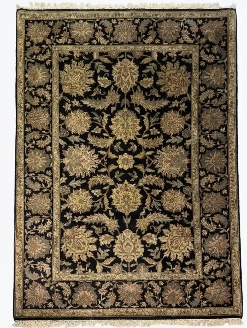 Full overhead view of a 6' x 9' 2" hand-knotted Indian wool rug with a black field and large-scale sage green and gold floral palmettes.