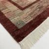 Detailed corner view of a burgundy Afghan Gabbeh rug showing the thick solid border and clean white hand-bound fringe.