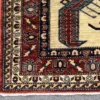 Detailed corner view of a red and ivory Afghan Kazak rug showing the ornate geometric border and clean white hand-bound fringe.