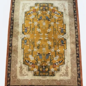 Full overhead view of a 9' x 6' hand-knotted China Ning wool rug with a vibrant saffron gold field, blue crane motifs, and a terracotta border.