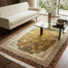 Bright modern living room with a white sofa and glass coffee table, featuring a 6x9 gold and terracotta Chinese wool rug.