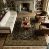 Bright modern living room with a neutral sofa and light wood floors, featuring a 5' 5" x 8' 7" black and terracotta Indian rug under a coffee table.