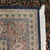 Close-up view of the underside of an Indian wool rug, showing the visible individual hand-tied knots and authentic textile constructio