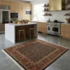 Contemporary kitchen with light wood cabinets and concrete floors, featuring a 6x6 square tobacco and rust rug in front of a marble island.