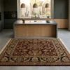 Minimalist modern kitchen with a large wooden island and concrete floors, featuring a 6x6 square red and black Indian wool rug.