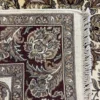 Close-up view of the underside of a square Indian wool rug, showing the visible individual hand-tied knots and authentic textile construction.