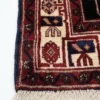 Detailed corner view of an Iranian Kuliai rug showing the multi-layered geometric border and authentic hand-bound edges with fringe.